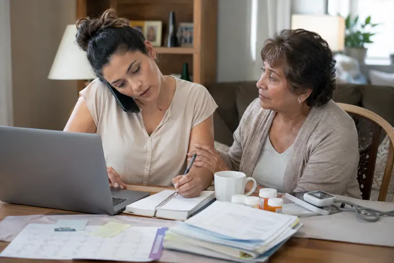 Female patient advocate helping a woman organize health insurance denial appeal documents